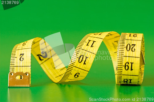 Image of  measure tape on green background