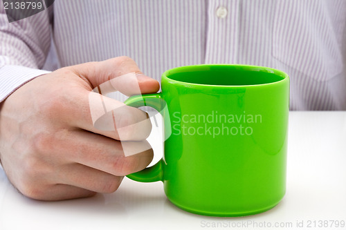 Image of businessman hold a green cup