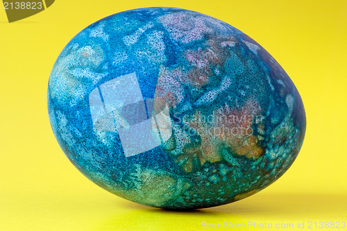 Image of blue easter egg  on yellow background