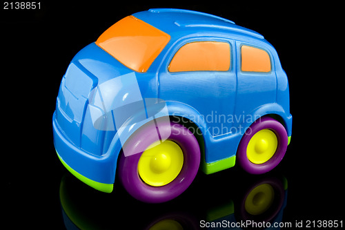 Image of blue plastic car on black background