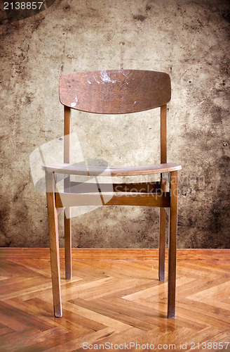 Image of wooden chair in a dirty room