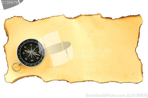 Image of compass on the piece of burnt paper