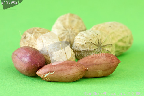 Image of peanuts over a green background