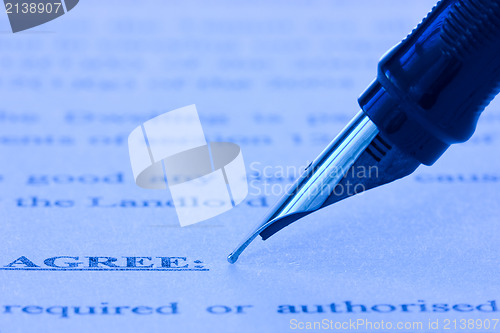 Image of fountain pen and printed agreement