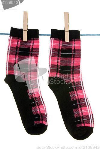 Image of two socks hang on rope