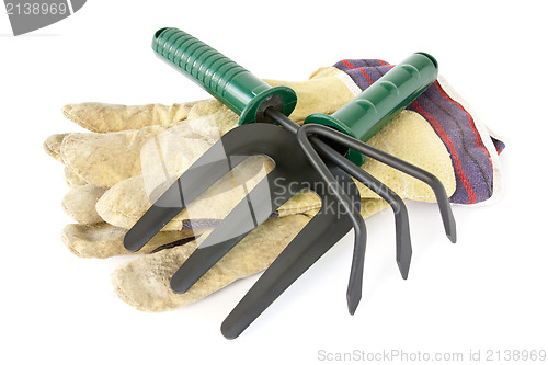 Image of work gloves with garden tools 