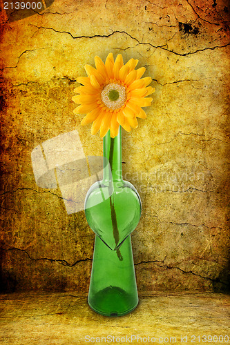 Image of green bottle with flower