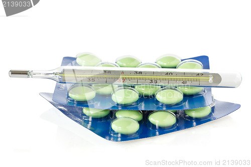 Image of Thermometer and green pills