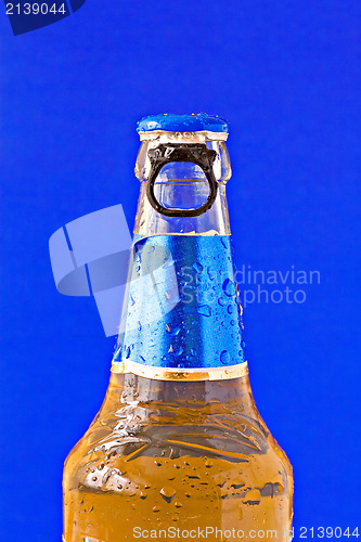 Image of bottle of beer on blue background