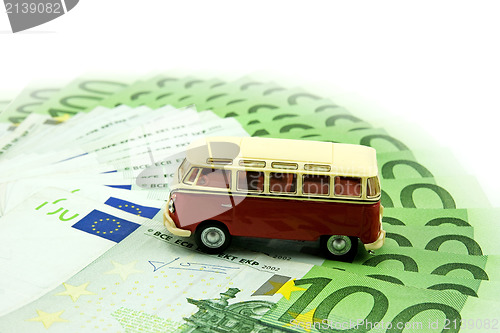 Image of red car and money 