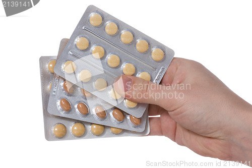 Image of Medical pills containers in a  hand