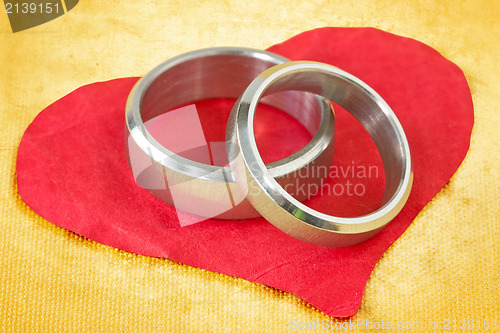 Image of wedding rings on paper heart