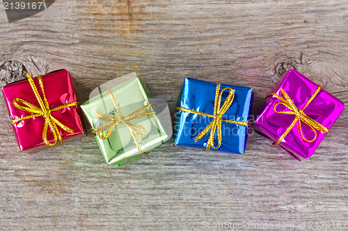 Image of Four gifts on the wooden floor