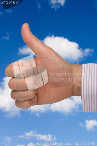 Image of thumb up on sky background