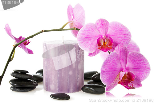 Image of orchid,aromatic candle and black stones 