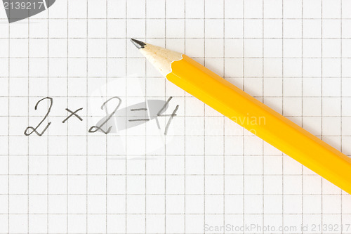 Image of math formula and pencil on squared paper