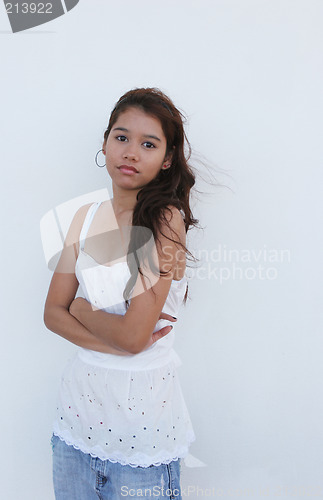 Image of Asian girl standing in front of a white wall