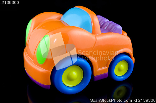 Image of orange plastic car on black