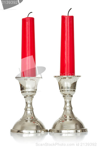 Image of  Two red candles on white background