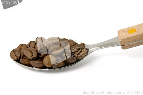 Image of spoon with coffee beans on white