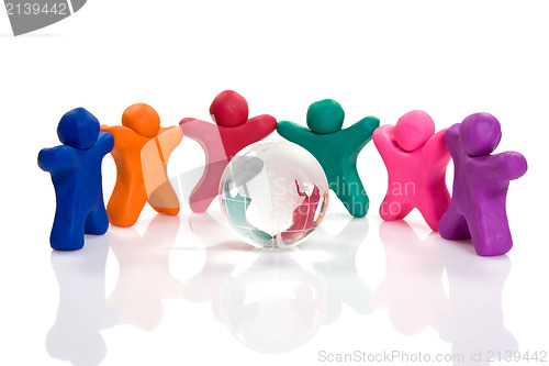 Image of plasticine people  surrounding a crystal globe