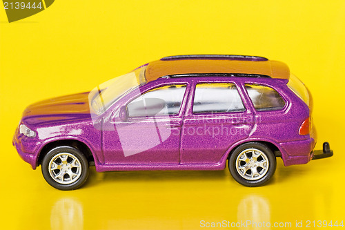 Image of purple car  on yellow background