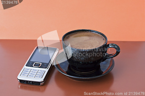 Image of cup of coffee and mobile phone