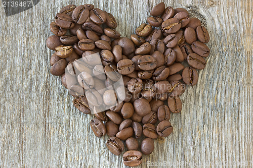Image of coffe beans heart on wood background