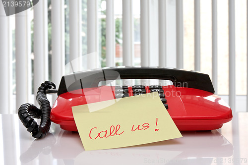Image of red office telephone