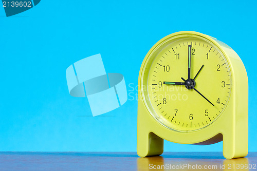 Image of alarm clock  against blue background