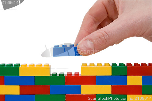Image of hand building lego