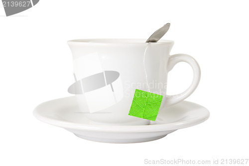 Image of white tea cup with green leaf label