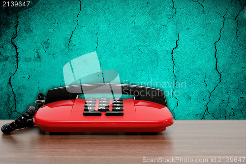 Image of  phone on dirty blue wall background