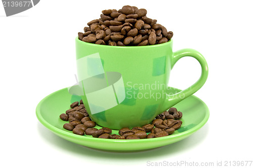 Image of cup with coffee beans over a white background