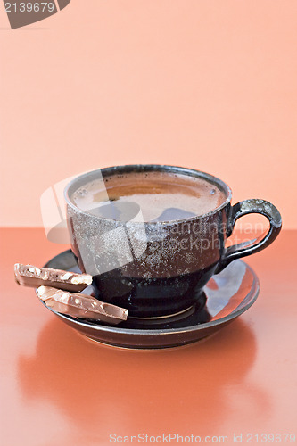 Image of coffee with two chocolate pieces
