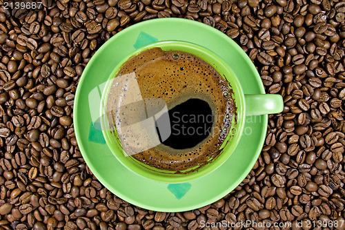 Image of coffee beans and green cup