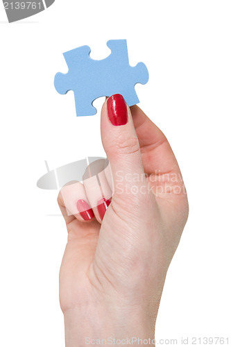 Image of hand with a piece of blue puzzle