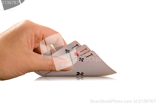 Image of hand holding three playing cards