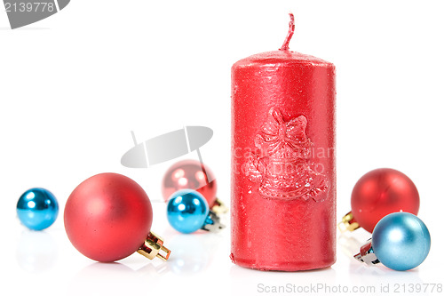 Image of red   candle and christmas baubles