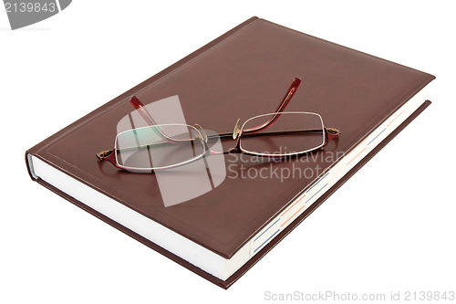 Image of eyeglasses and book