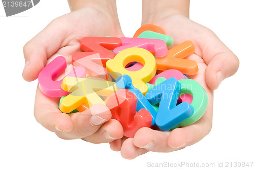 Image of child hands with color alphabet