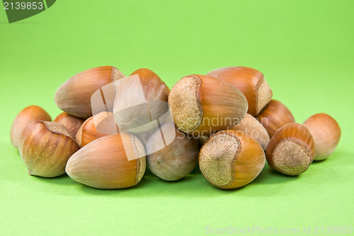 Image of hazelnuts on the green background