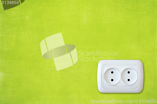 Image of  green wall with white electric outlet