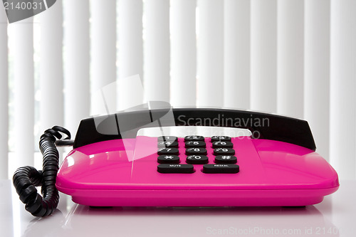 Image of pink office telephone