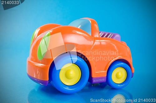 Image of orange car toy over a blue 