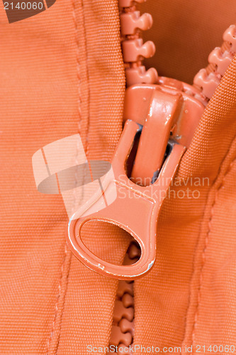 Image of zipper of a orange jacket