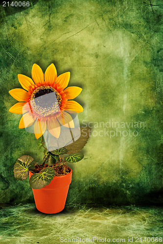 Image of artificial sunflower on dark green background