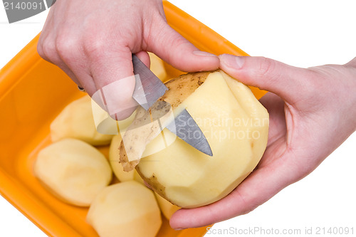 Image of hands peeling potatoes