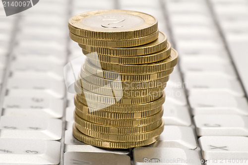 Image of  stack of coins on computer keyboard