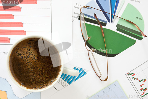 Image of morning coffee with business documents
